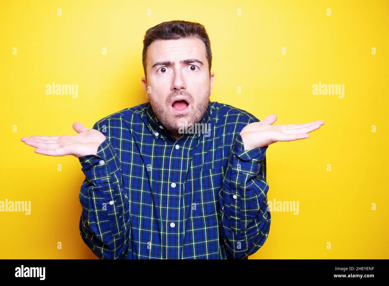 Portrait of an astonished isolated on yellow background Stock Photo