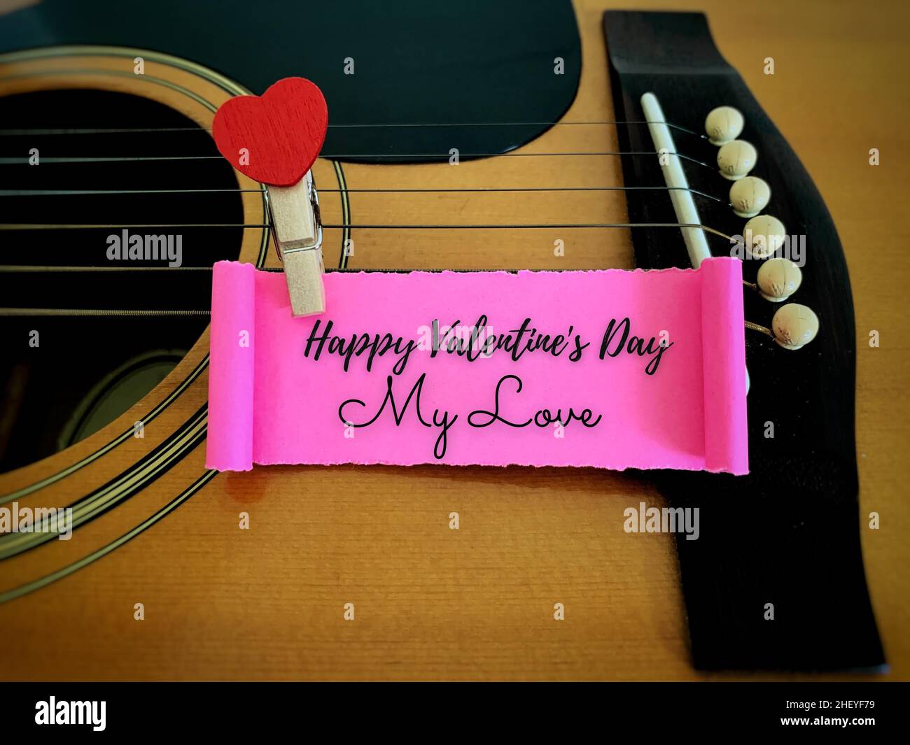 Happy Valentine's day my love label on torn paper with guitar and ...
