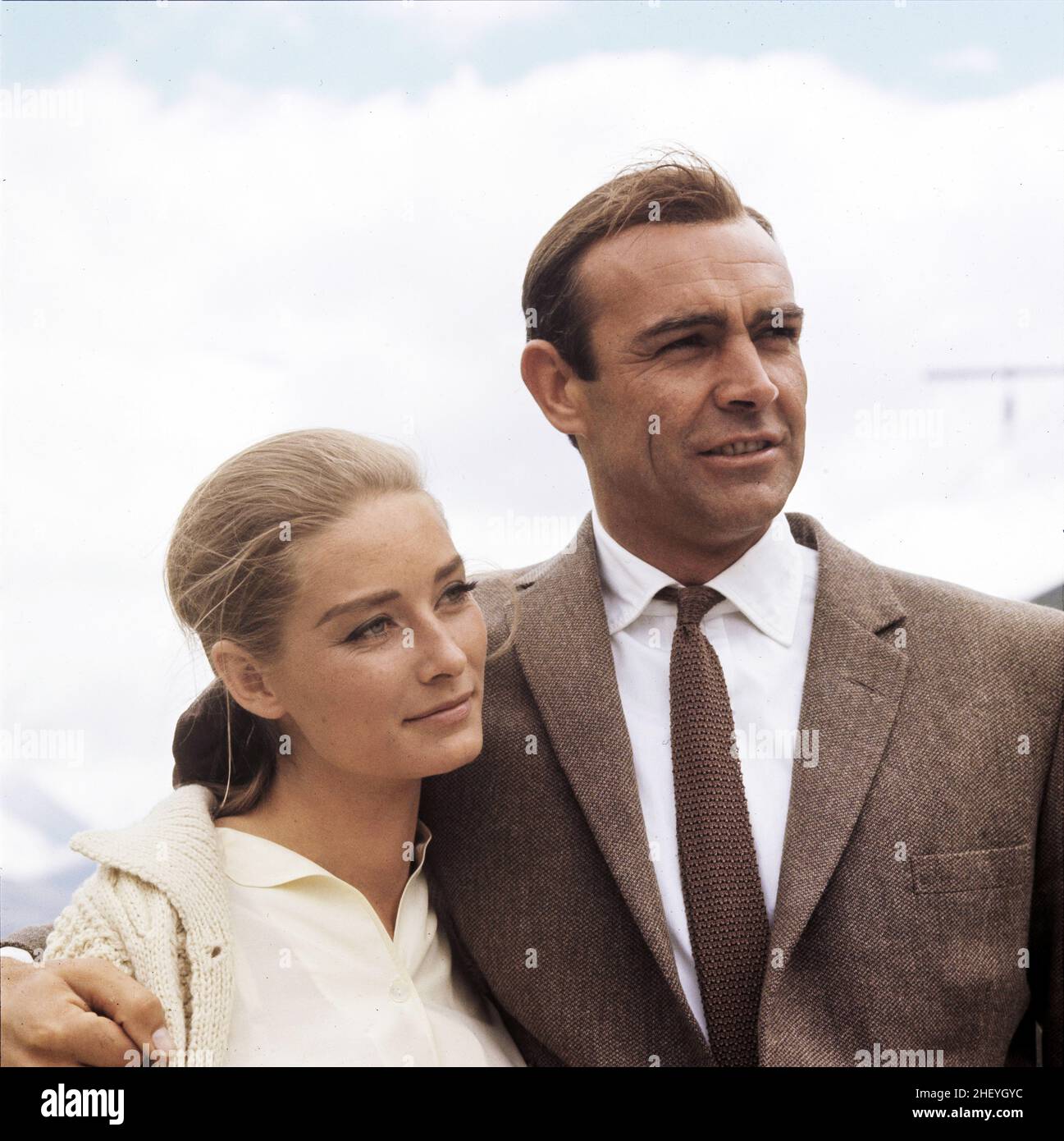Sean Connery as James Bond 007 and Tania Mallet as Tilly Masterson in 'Goldfinger' while filming at Furka Pass and Andermatt in the Swiss Alps Stock Photo