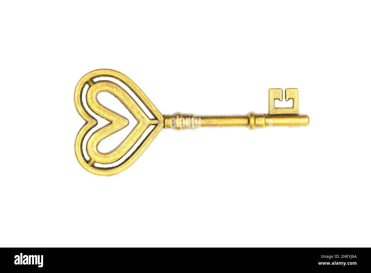 Retro style gold toned heart shaped key isolated on white background ...