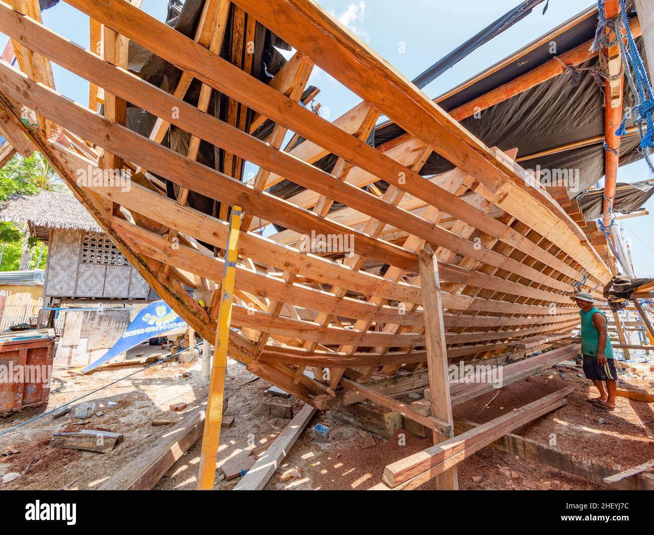 Traditional Philippine fishing boat, a basnigan, under construction at a local shipyard in the village of Tinoto, Maasim in the Sarangani province in Stock Photo