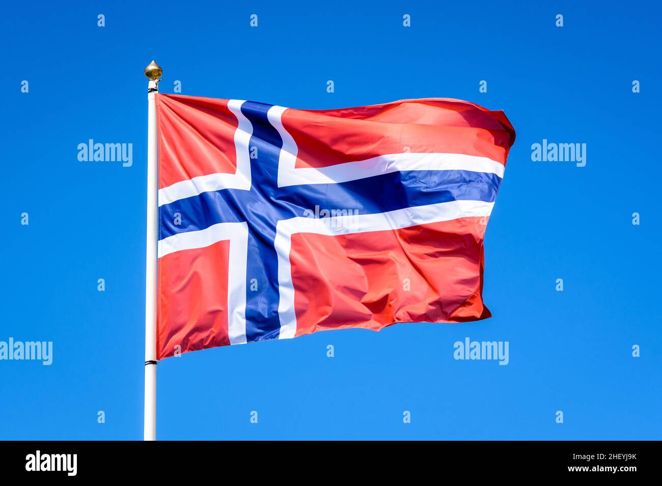 The national flag of Norway is flying in the wind at full mast against ...