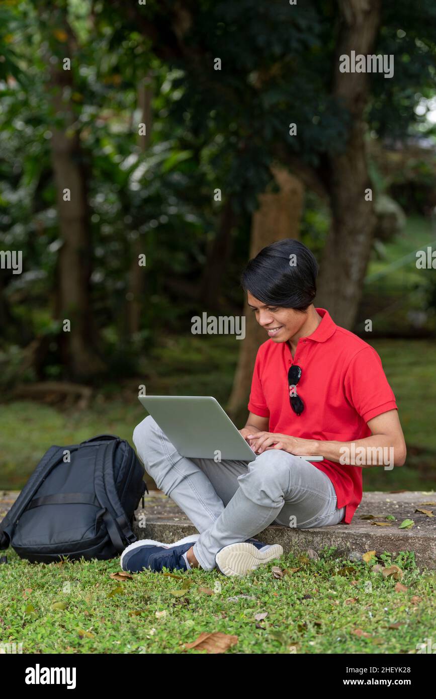 Man sitting under tree reading hi-res stock photography and images - Alamy