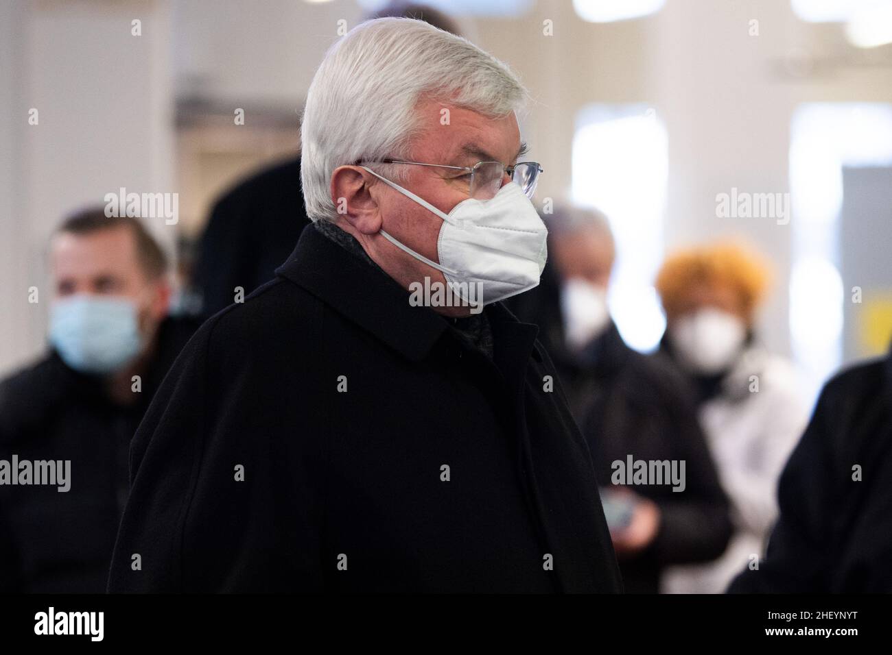 Cologne, Germany. 13th Jan, 2022. Günter Assenmacher, former church judge of the Archdiocese of Cologne, waits at the security desk of the regional court. Assenmacher is to testify as a witness in an abuse trial. The defendant before the Cologne Regional Court is a Catholic priest who is alleged to have abused his three nieces as children in Gummersbach in the 1990s. Credit: Federico Gambarini/dpa/Alamy Live News Stock Photo