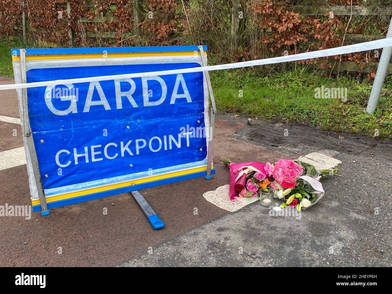 Flowers are left at a Garda checkpoint in Tullamore after a young woman, who has been named locally as Ashling Murphy, was killed in Co Offaly. She died after being attacked while she was jogging along the canal bank at Cappincur at around 4pm on Wednesday. Picture date: Thursday January 13, 2022. Stock Photo