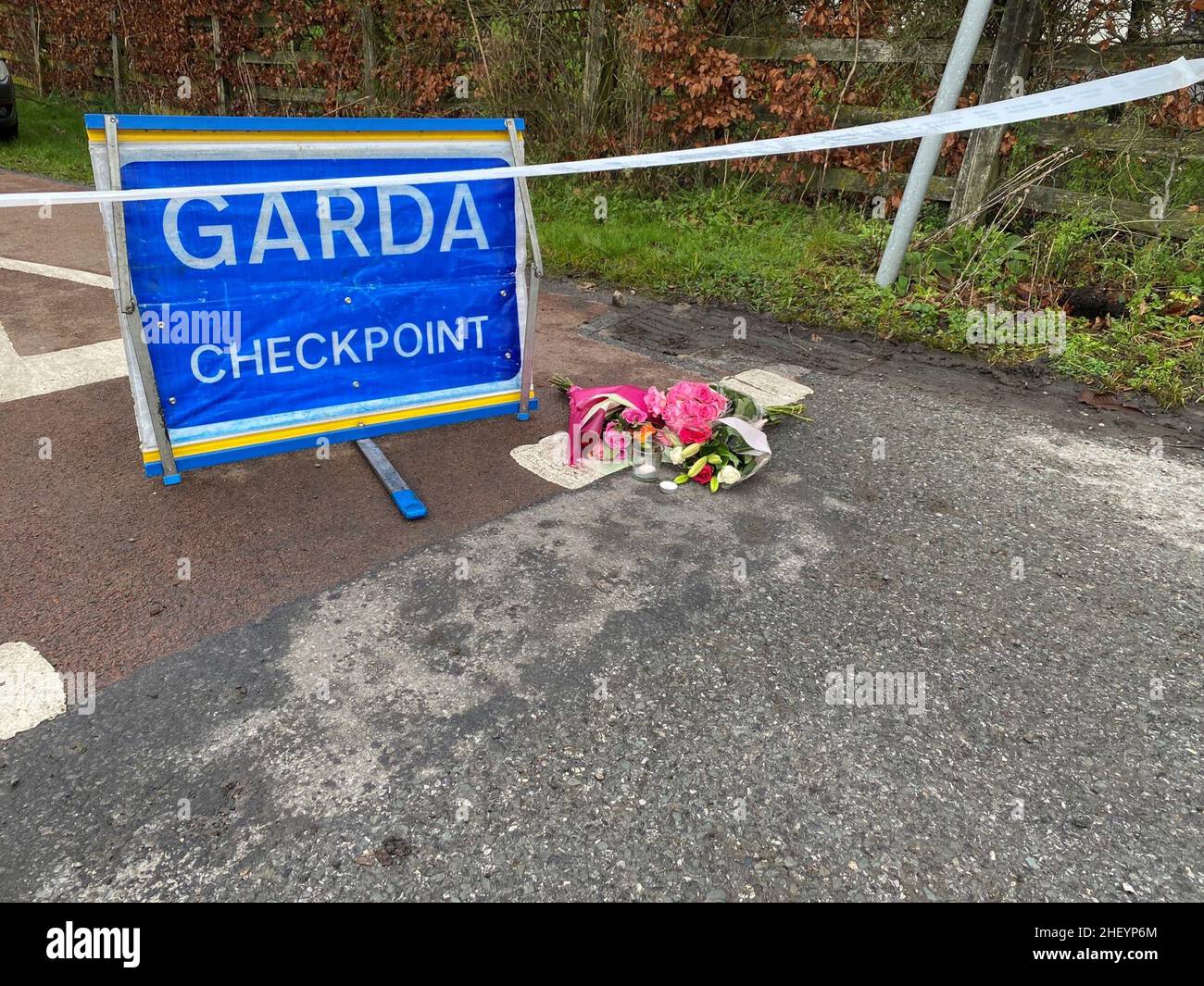 Flowers are left at a Garda checkpoint in Tullamore after a young woman, who has been named locally as Ashling Murphy, was killed in Co Offaly. She died after being attacked while she was jogging along the canal bank at Cappincur at around 4pm on Wednesday. Picture date: Thursday January 13, 2022. Stock Photo