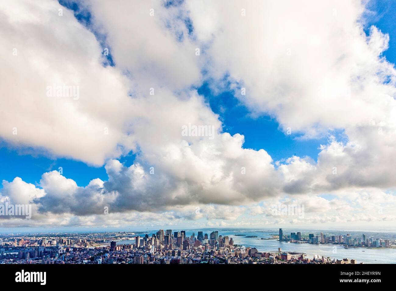 view over New York under blue sky with white clouds Stock Photo - Alamy
