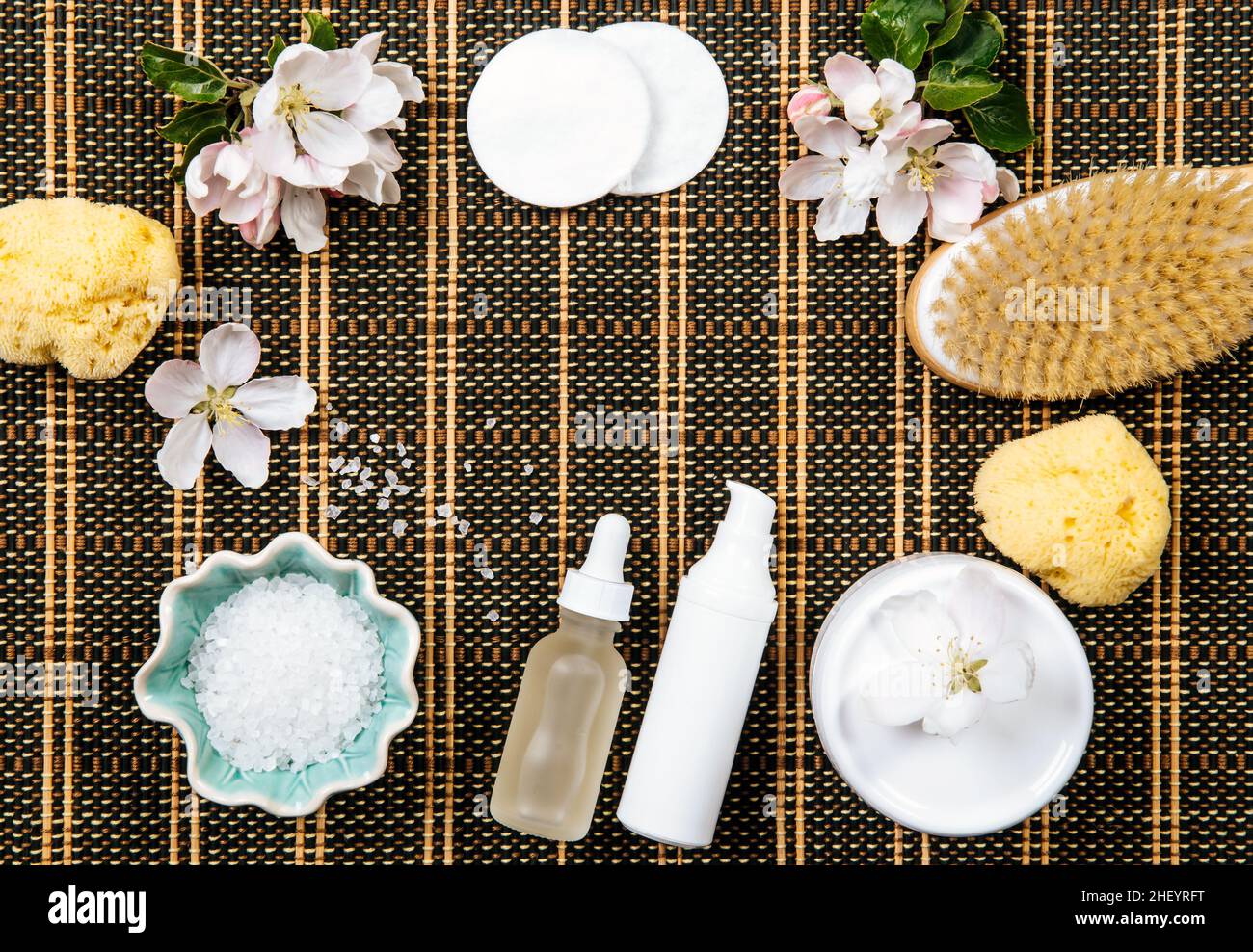 Spa body and skin care products background frame. Copy space in the center. Various beauty products: bath salt, sponge, moisturizing creams. Stock Photo