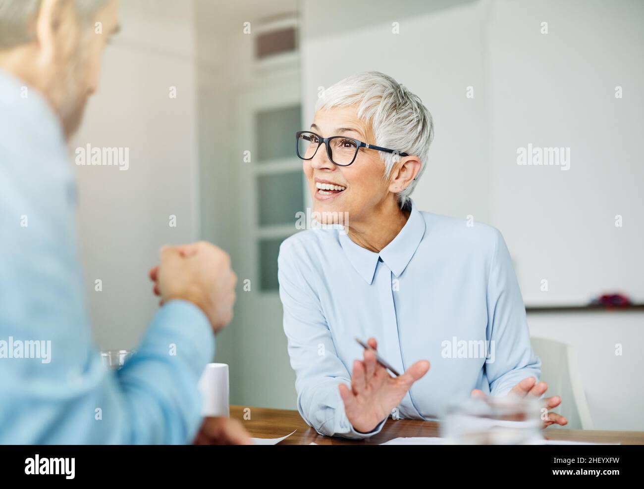 business office person discussion document papers teamwork senior meeting Stock Photo