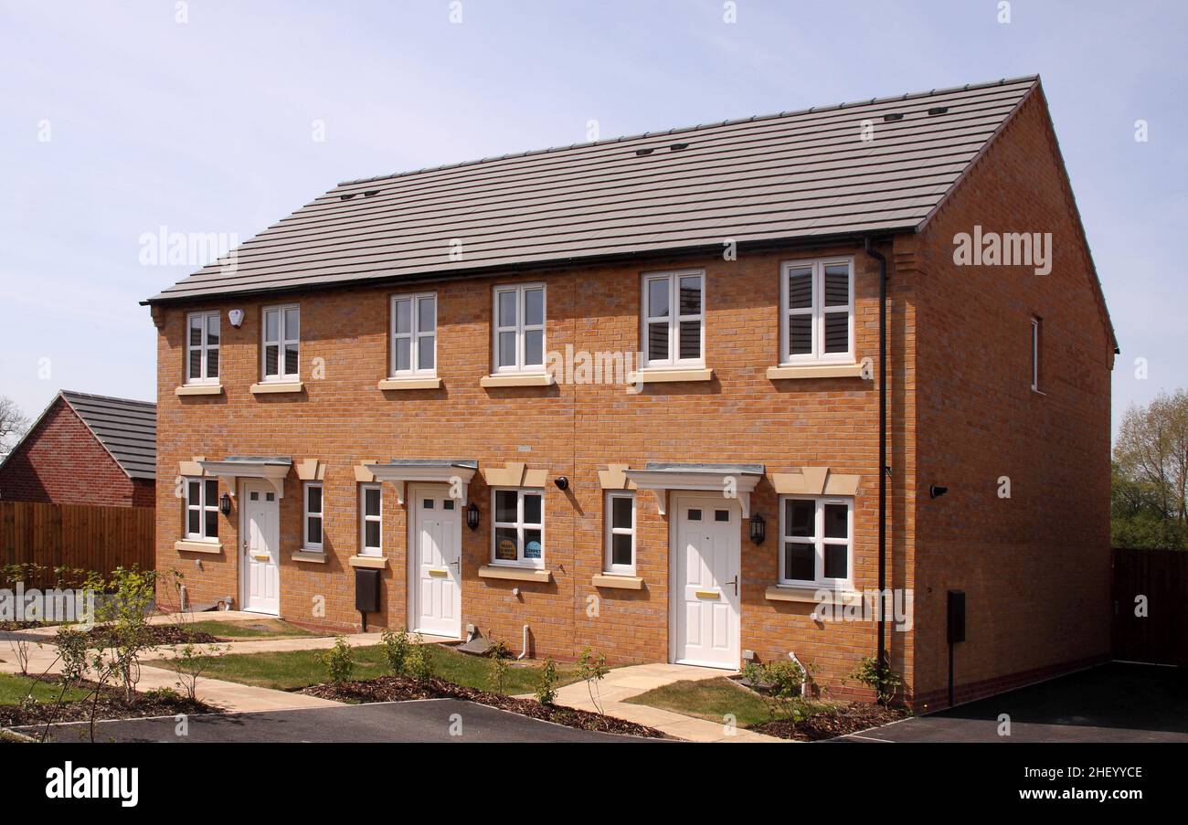 Modern housing estate development, showhomes and street scene, terrace of three small properties houses. Stock Photo