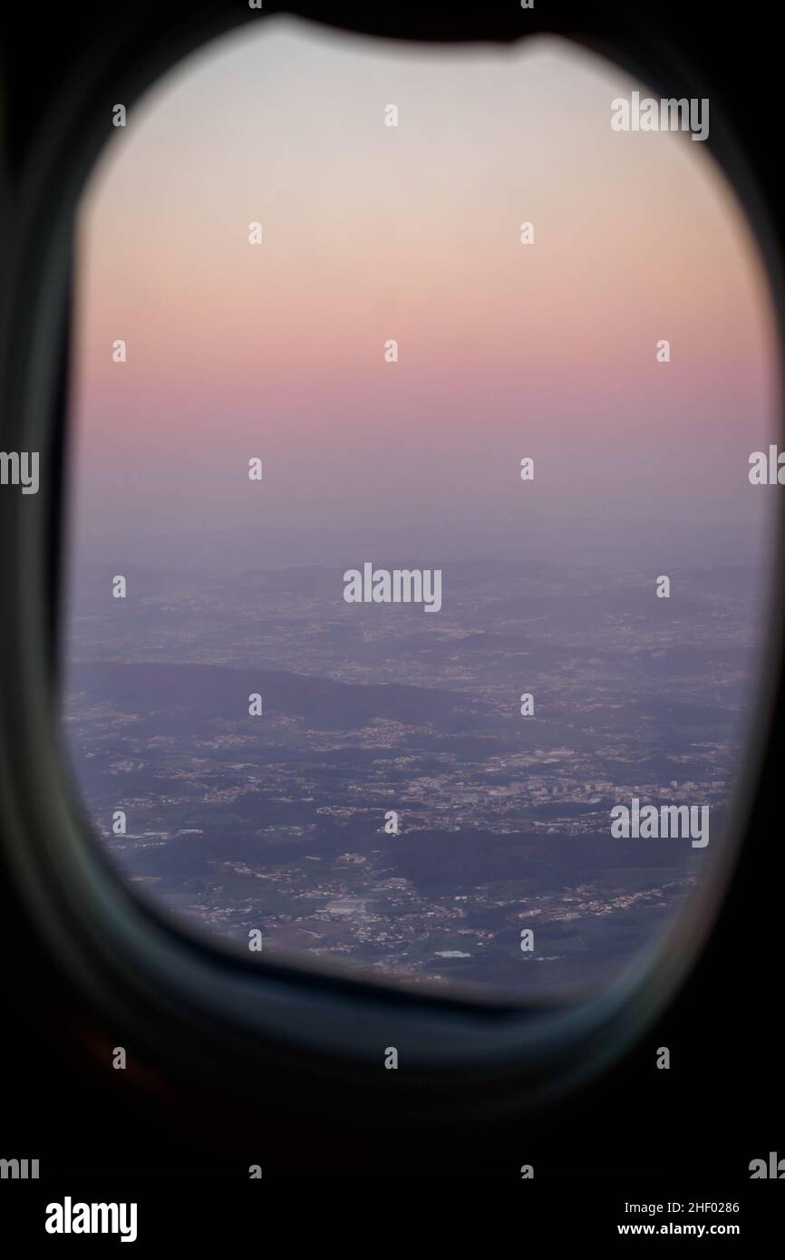 Sunset view through an airplane window in Porto, Portugal Stock Photo