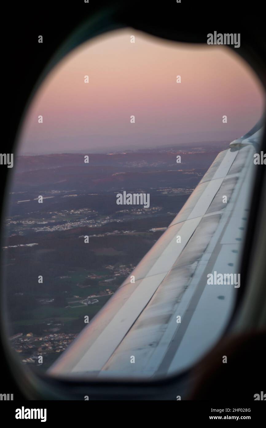 Sunset through an airplane window in Porto, Portugal Stock Photo