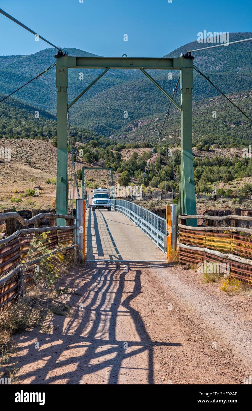 Truck camper at suspension bridge over Green River, Browns Park NWR, Colorado, USA Stock Photo