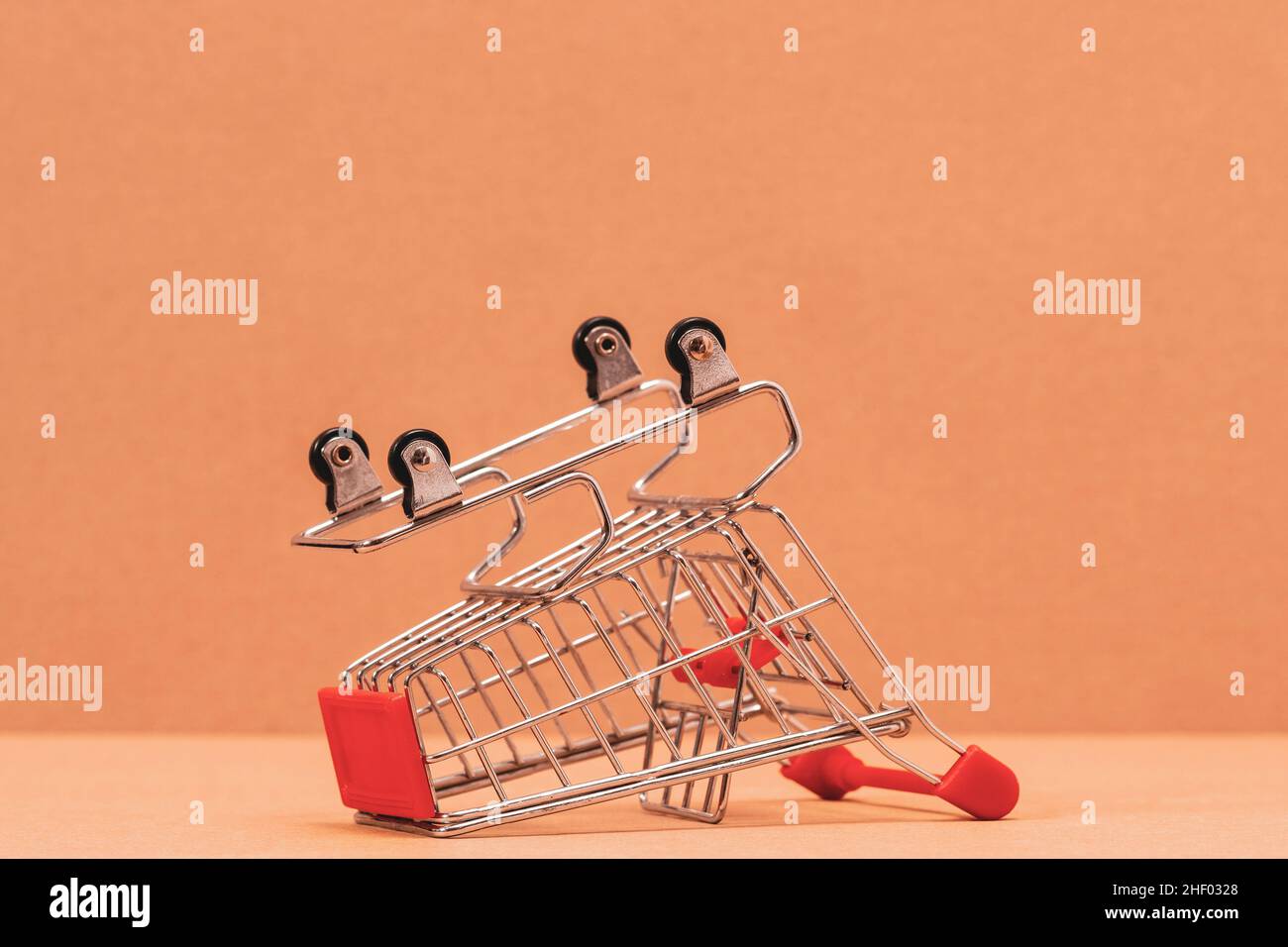 Shopping cart is upturned, concept symbol of bankruptcy, crisis and other. Stock Photo