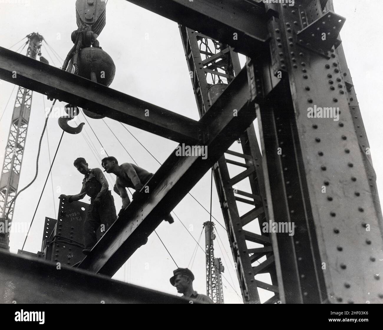 Construction workers high up on Empire State Building, c 1930. Vintage