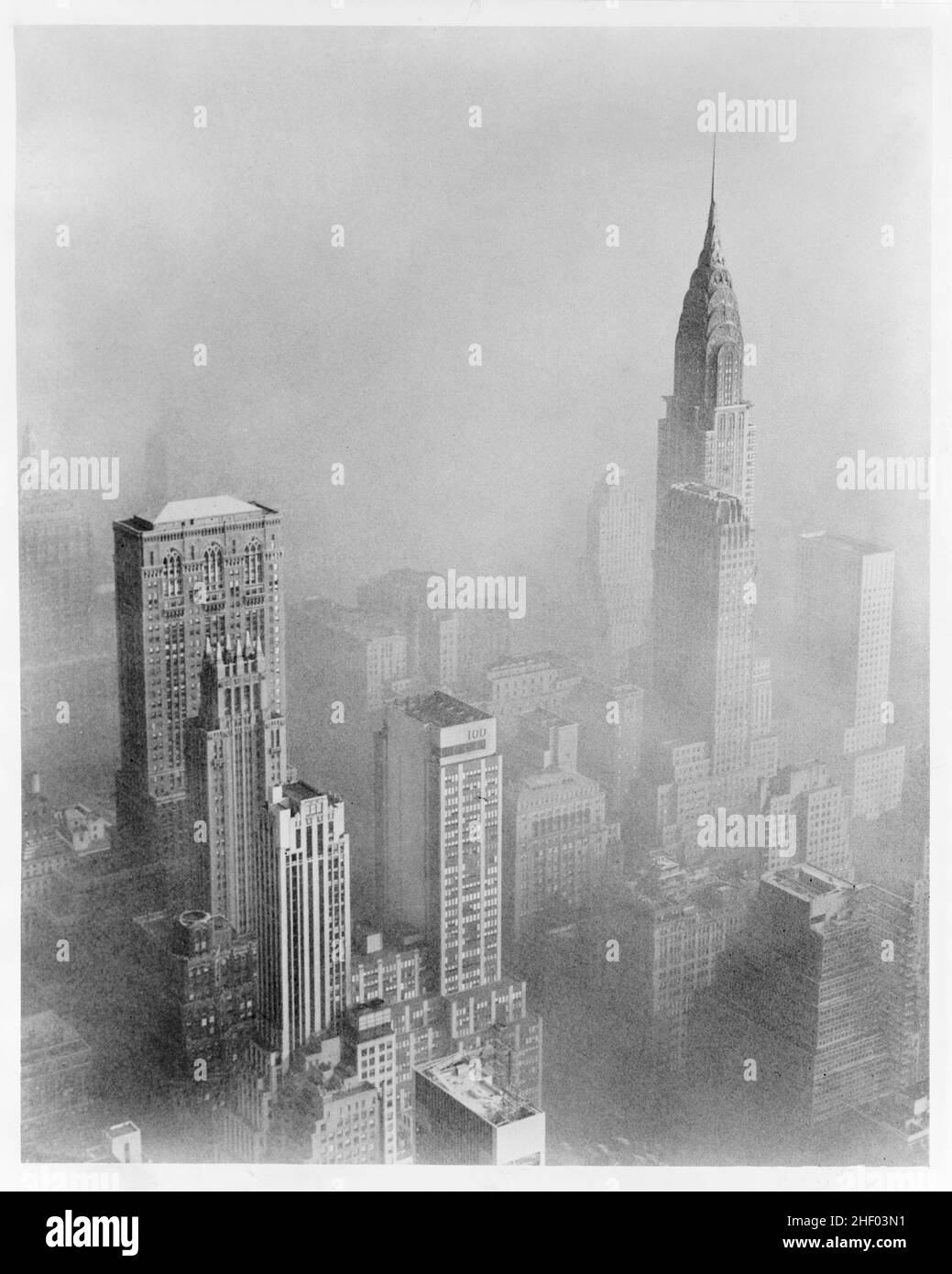 Smog obscures view of Chrysler Building from Empire State Building, New York City, 1953. Albertin, Walter, photographer. Vintage. Stock Photo