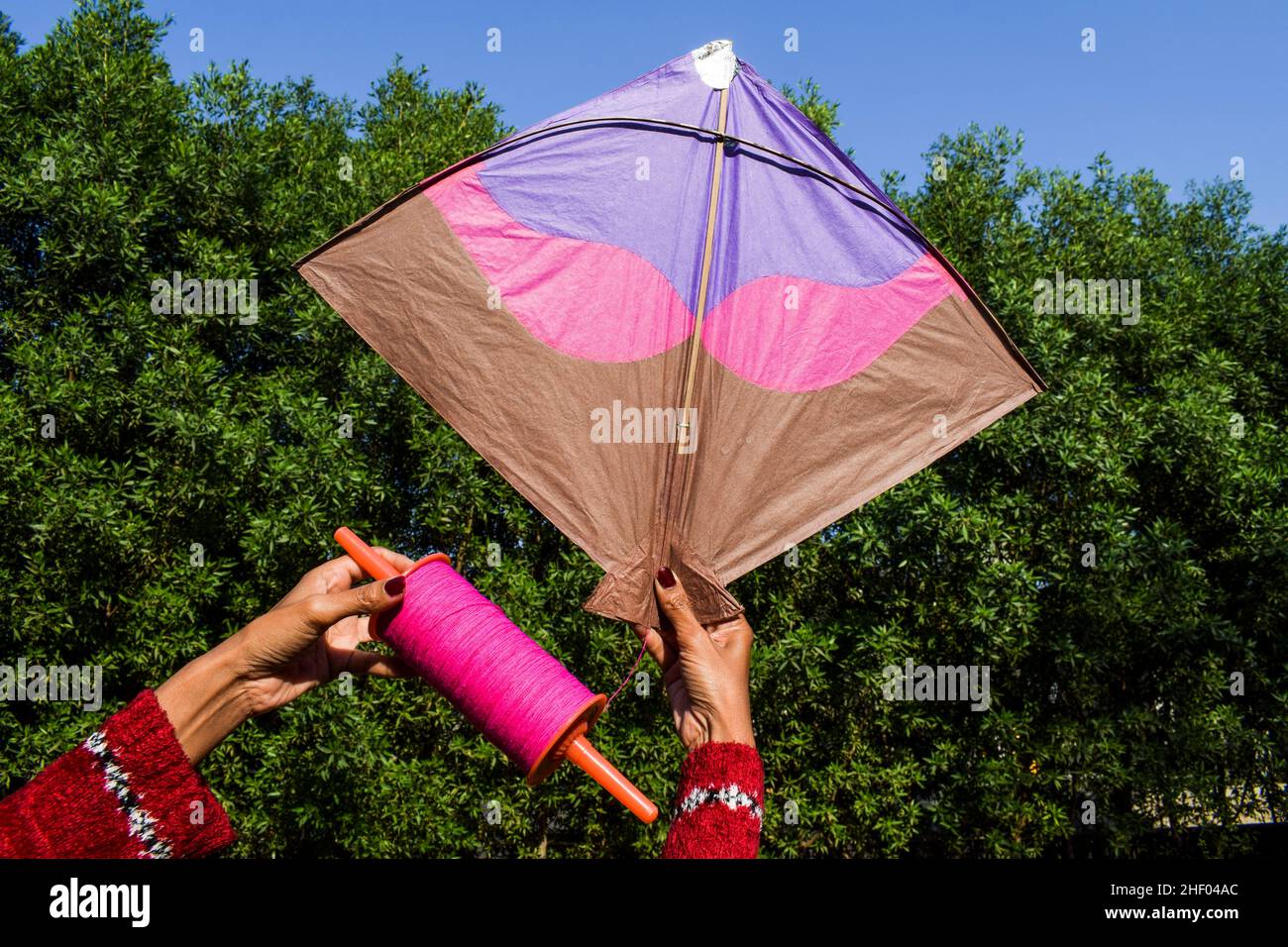Female flying kite with sky background on occasion of Indian kite