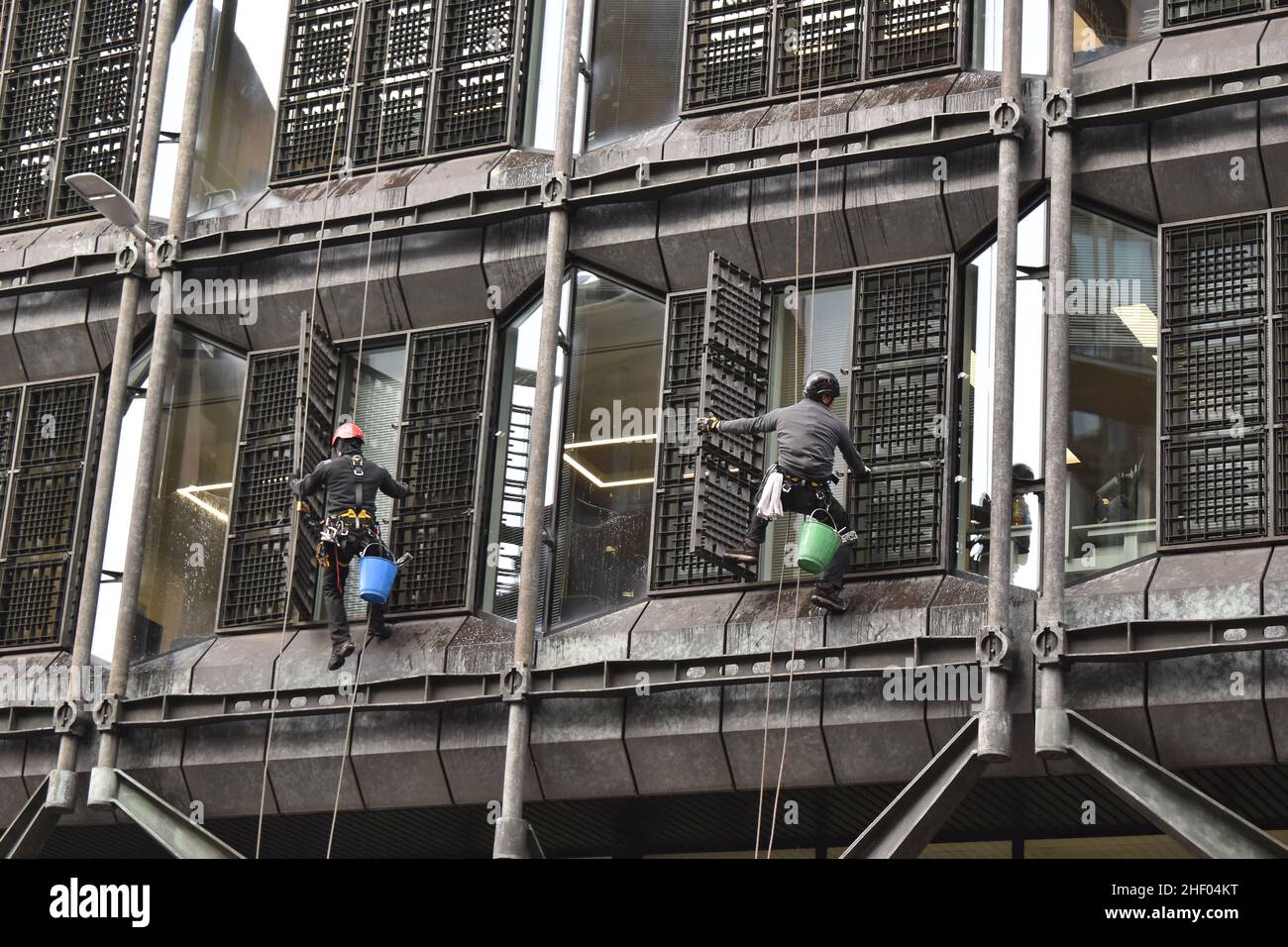 Workers cleaning windows of modern office building at Queen Victoria Street London UK. Stock Photo