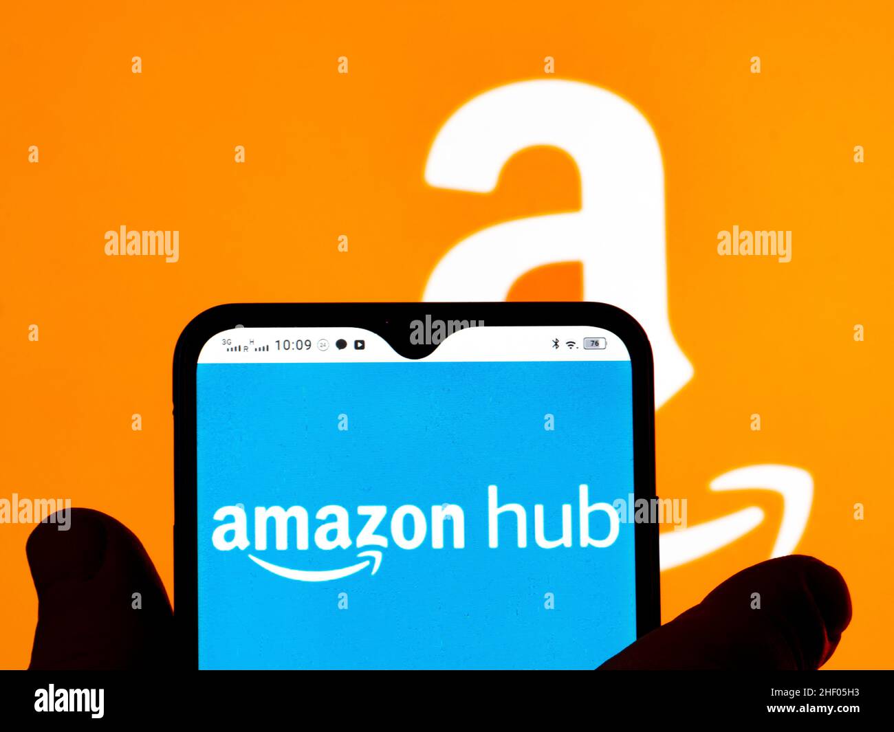 In this photo illustration, the Amazon Hub logo is seen displayed on a smartphone screen and Amazon logo in the background. (Photo by Igor Golovniov / SOPA Images/Sipa USA) Stock Photo