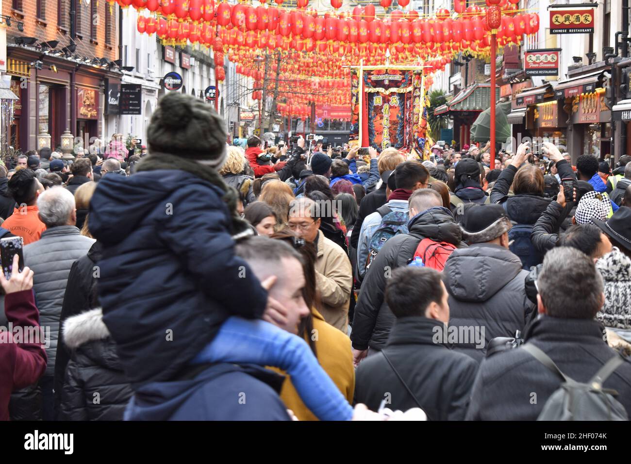 Crowded street of Chinatown, people celebrating Chinese New Year 2020 in London UK. Stock Photo