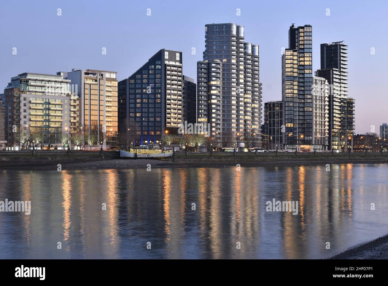 Corniche, Dumont and Merano - contemporary mixed-use developments reflecting in river Thames at dusk, Albert Embankment in London Borough of Lambeth. Stock Photo