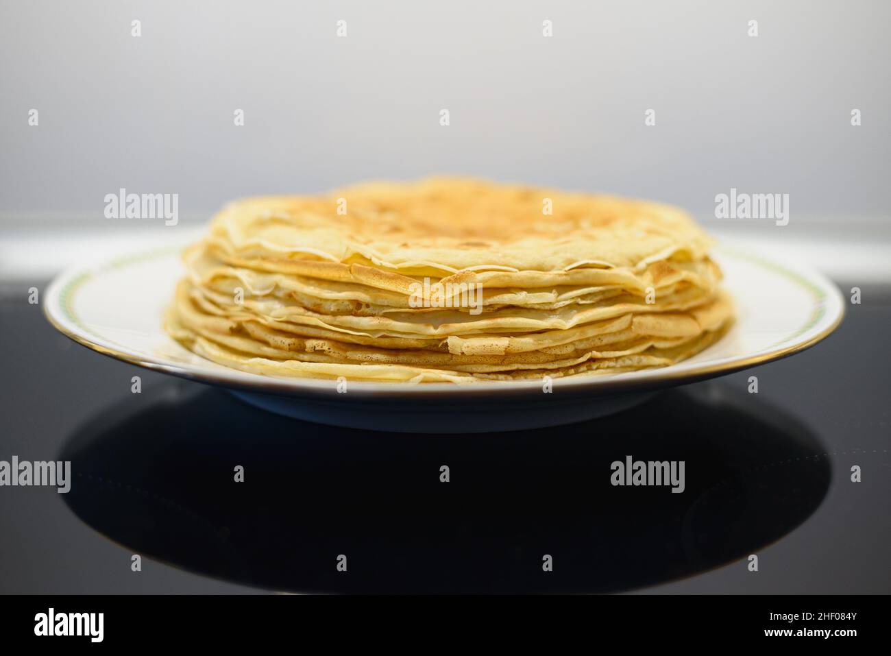 Stack of crepes or thin pancakes in a plate Stock Photo