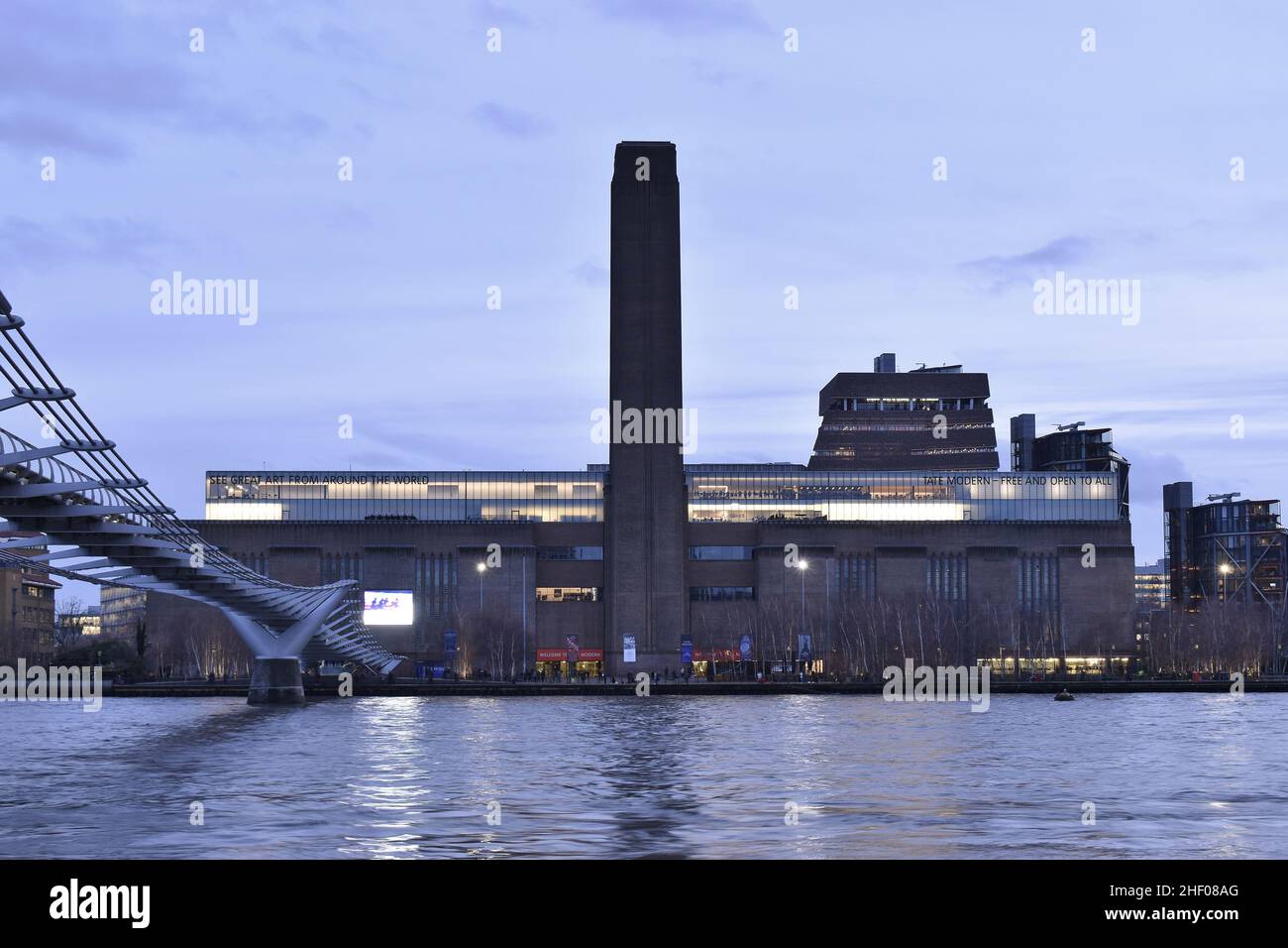 Tate Modern Art Galley building on the south bank of river Thames, dusk view from the north bank, London UK. Stock Photo