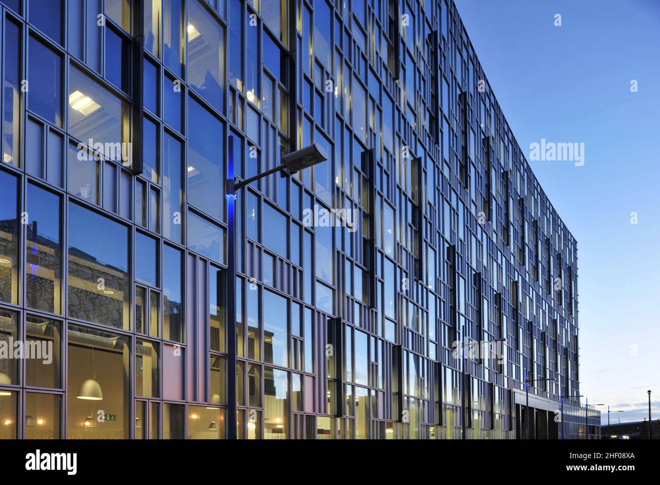 14 Pier Walk - modern office building glass facade at dusk, located in North Greenwich London UK. Stock Photo