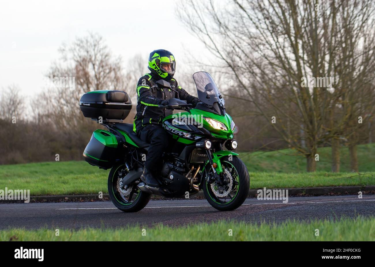 Man riding a Kawasaki Versys motorcycle Stock Photo