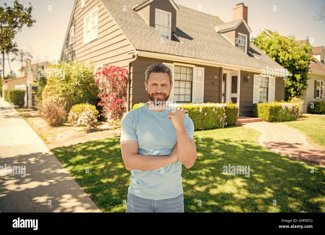 cheerful mature man pointing finger on house, owner Stock Photo Alamy