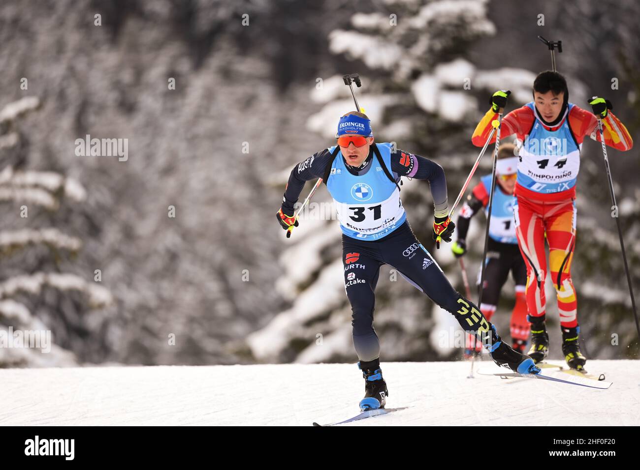 Ruhpolding, Germany. 13th Jan, 2022. Biathlon: World Cup - Sprint 10 km, men: Erik Lesser from Germany (l) runs ahead of Fangming Cheng from China. Credit: Sven Hoppe/dpa/Alamy Live News Stock Photo