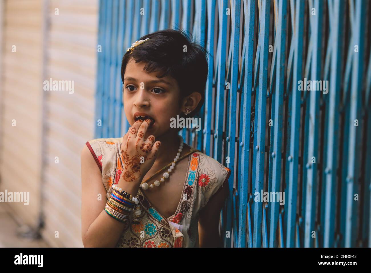 Peshawar, Pakistan - June 08, 2020: Smiling Pakistani Girl with Cut Dark Hair and Colorful Dress Stock Photo