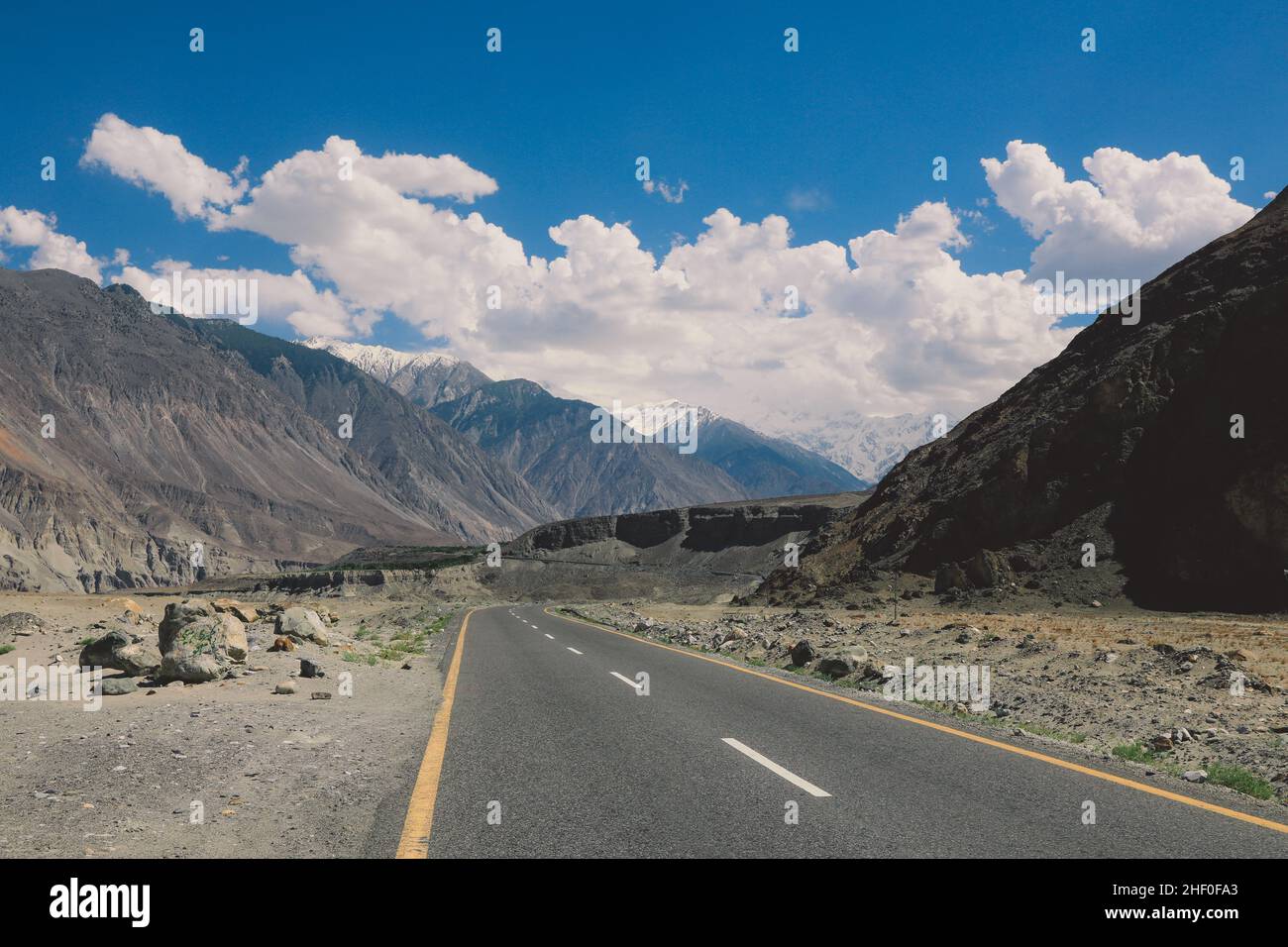 Asphalt Road in the High Gilgit Baltistan Mountains under the Blue