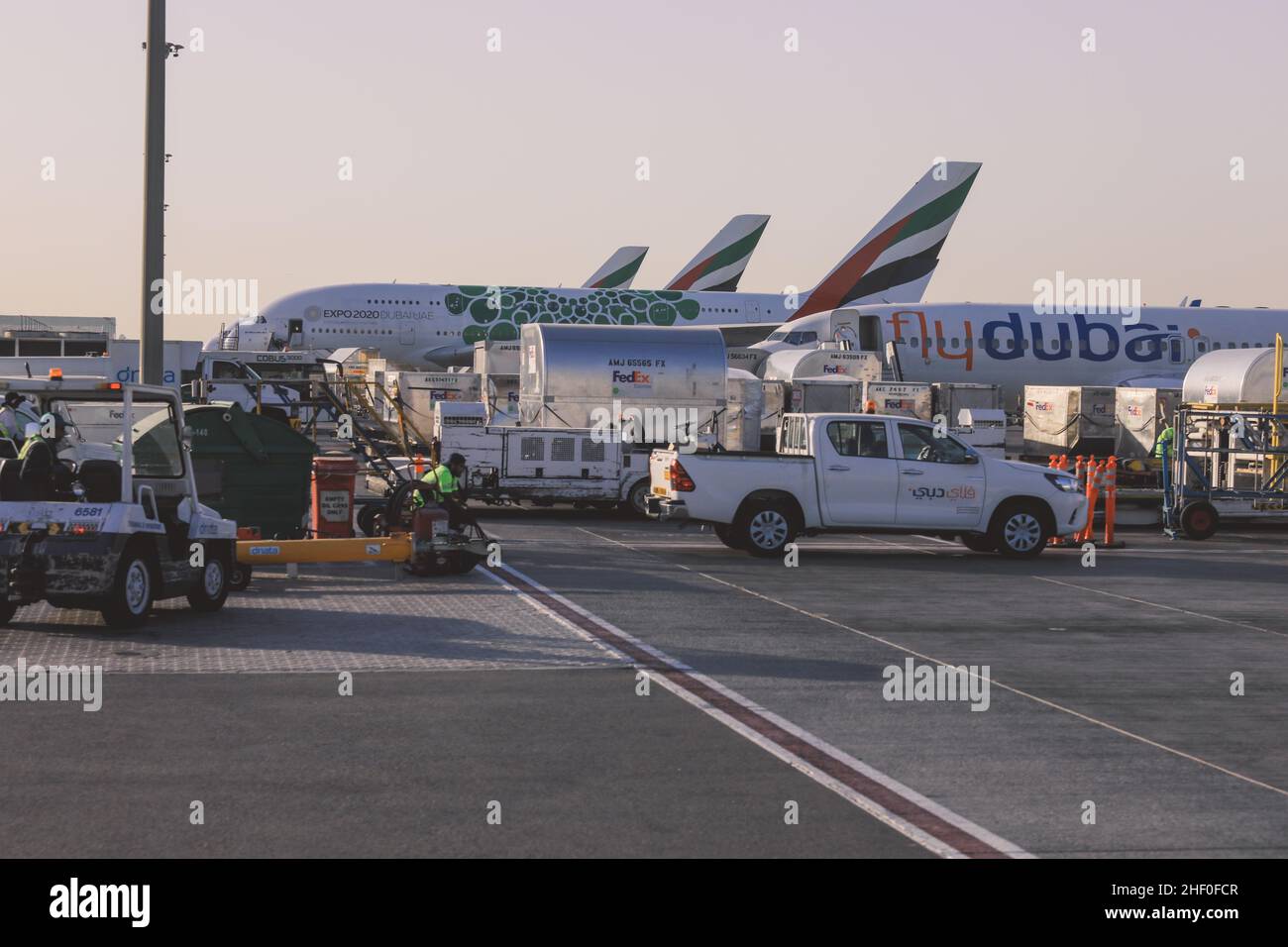 Dubai, United Arab Emirates - June 10, 2021: View to the Service Cars and Aircraft in the International Airport Stock Photo