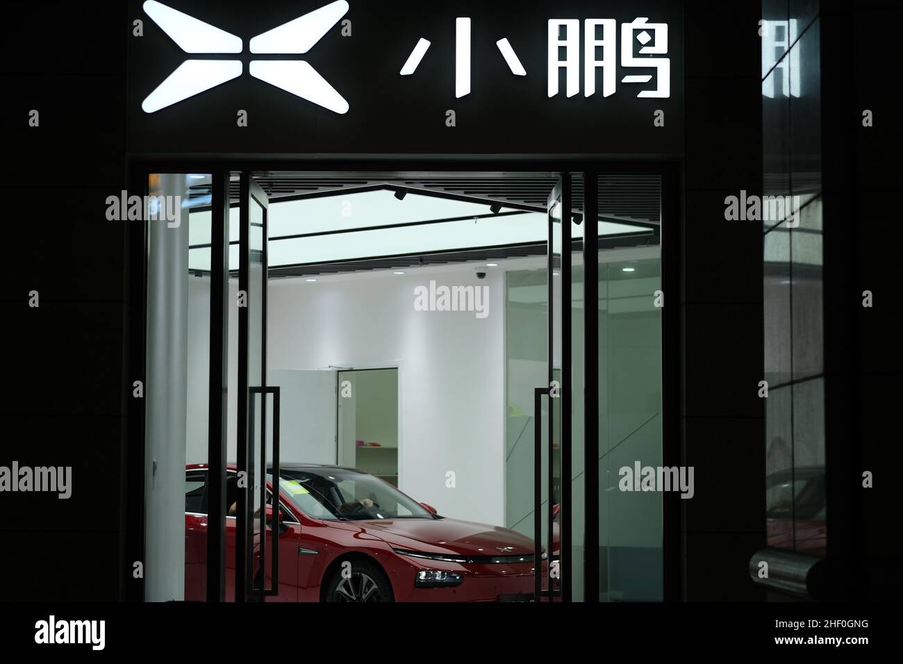 Xpeng Motors's store sign at night. Electric car in store. Xpeng is a Chinese electric vehicle company Stock Photo