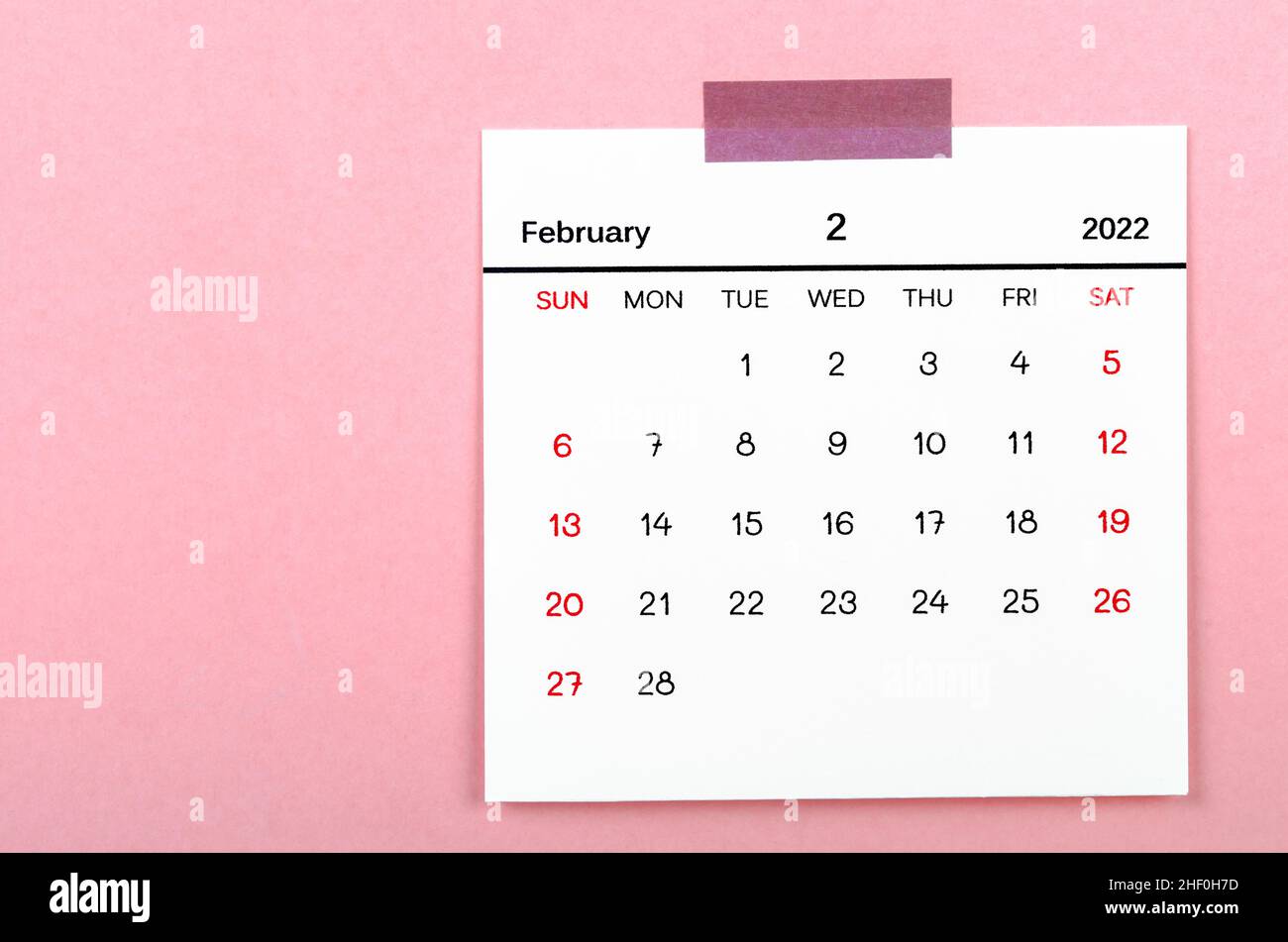 The February 2022 calencar on pink background. Stock Photo