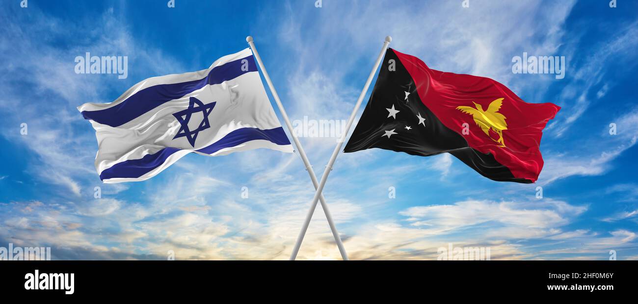 crossed national flags of Israel and Papua New Guinea flag waving in the wind at cloudy sky. Symbolizing relationship, dialog, travelling between two Stock Photo