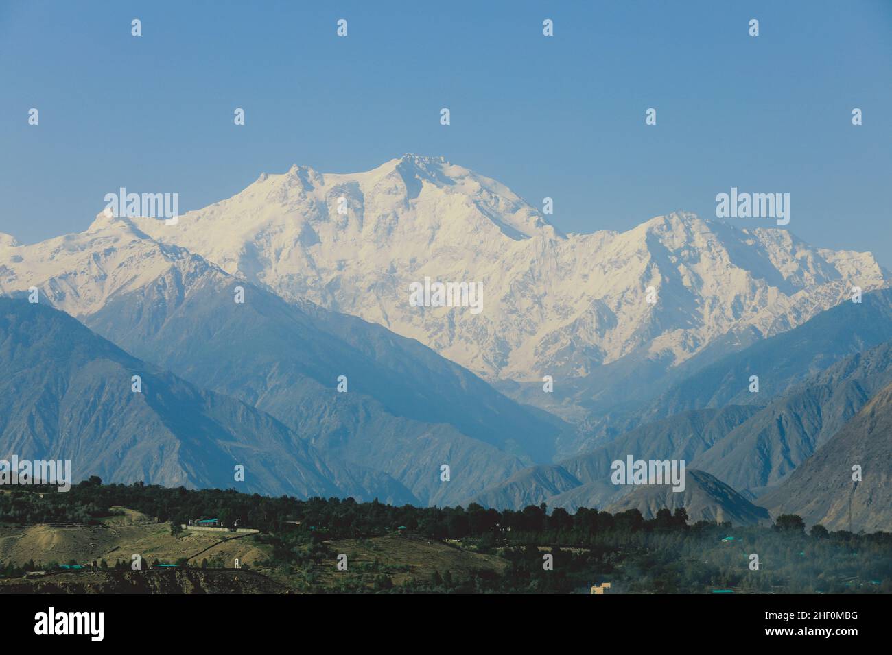 Amazing View to the Snow Capped Mountain Peaks in the Gilgit Baltistan Highlands under the Blue Sky, Pakistan Stock Photo