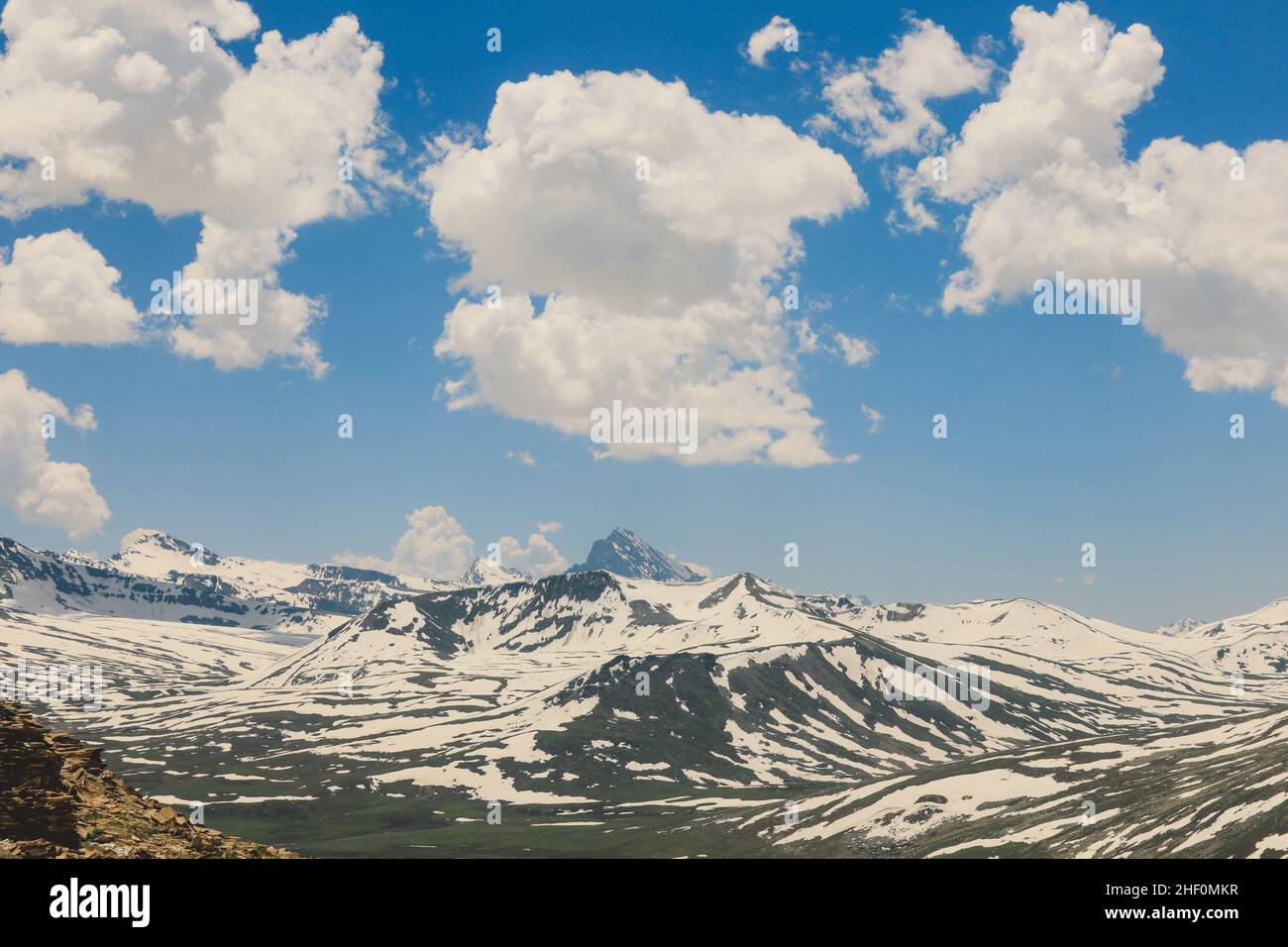Amazing View to the Snow Capped Mountain Peaks in the Gilgit Baltistan Highlands under the Blue Sky, Pakistan Stock Photo