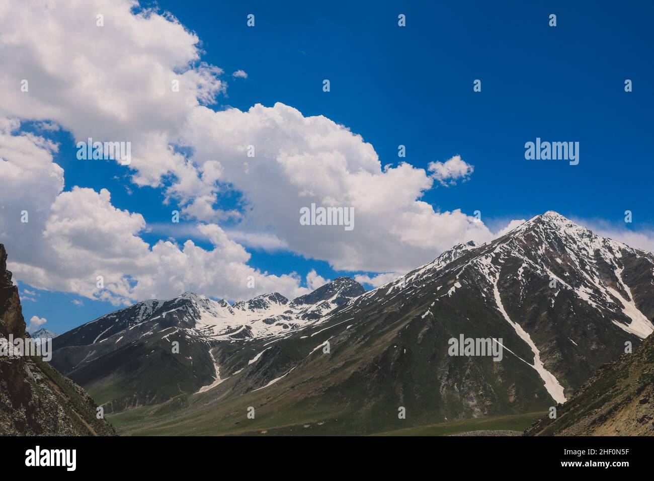 Amazing View to the Snow Capped Mountain Peaks in the Gilgit Baltistan Highlands under the Blue Sky, Pakistan Stock Photo