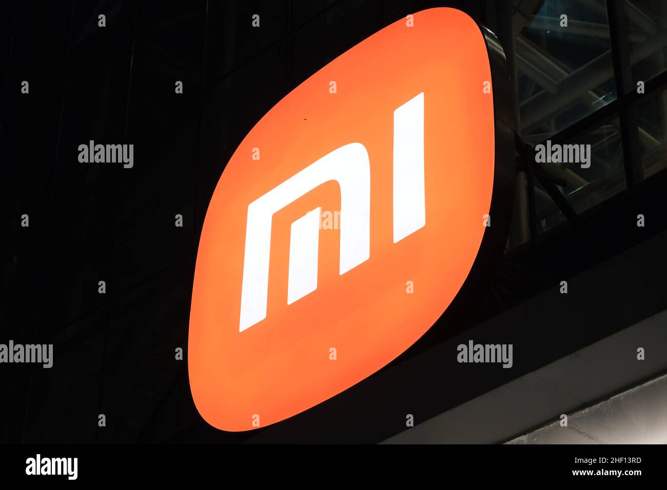 close up Xiaomi logo at dark night.  Xiaomi Corporation registered in Asia as Xiaomi Inc., is a Chinese multinational electronics company Stock Photo