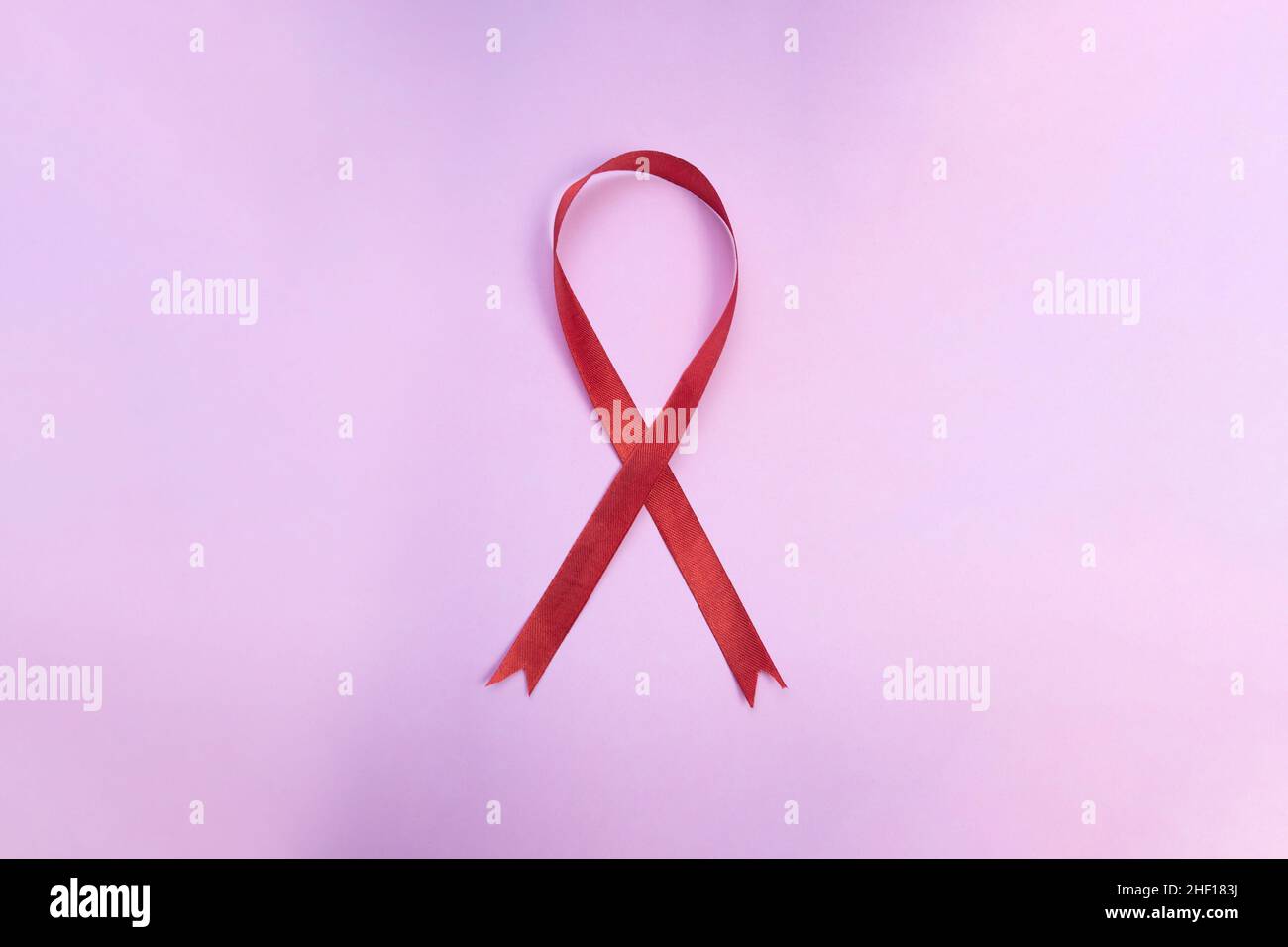 Red Ribbon on pink Background National HIV Testing Day, World Aids Day. Awareness Campaign Stock Photo