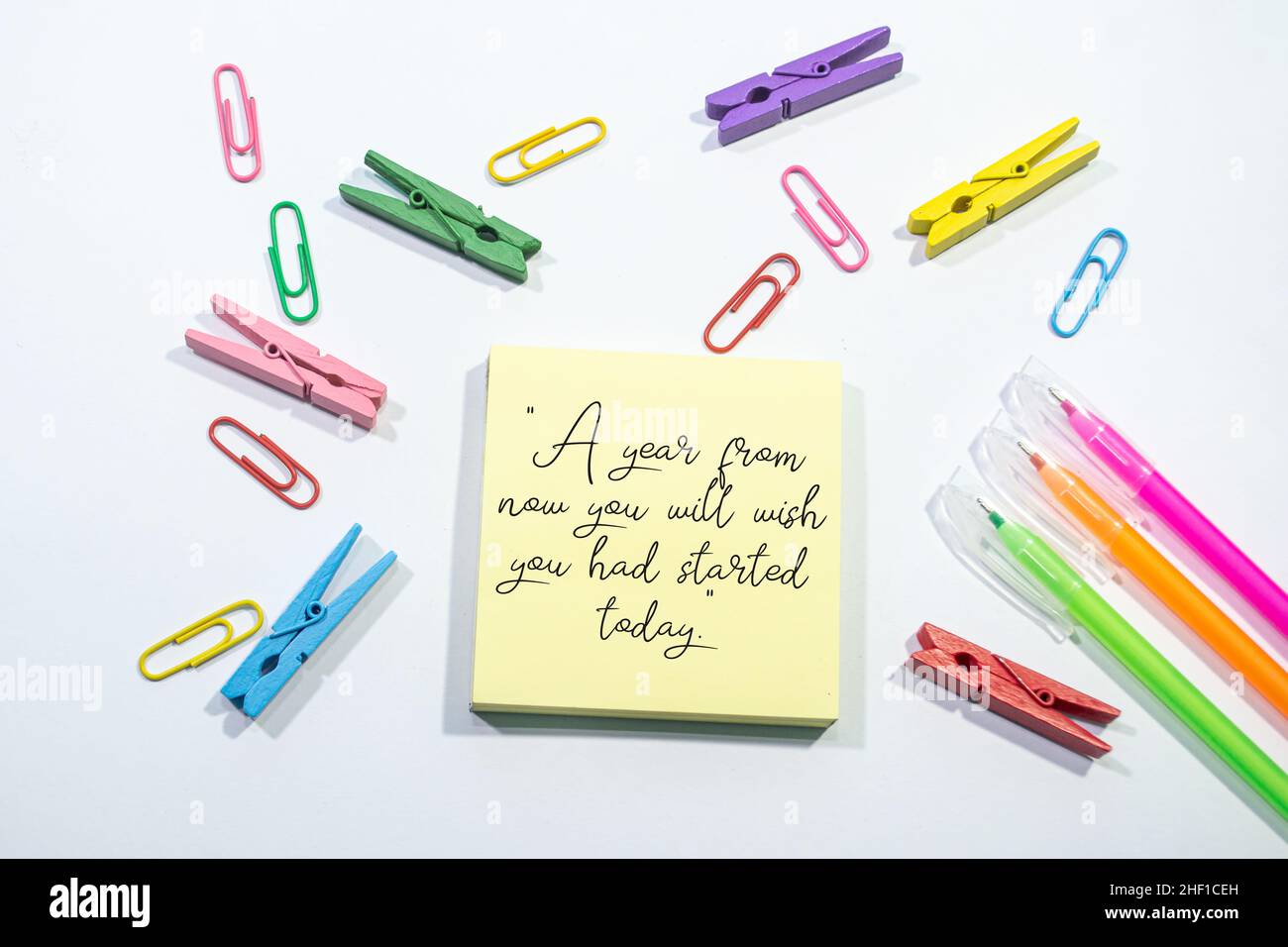 A year from now you will wish you had started today Motivational quote on Set of colorful paper clips with white copy space background. Stock Photo
