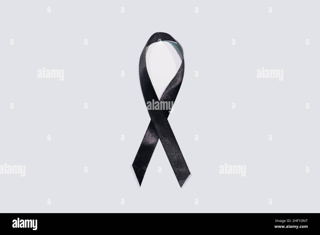 Black awareness ribbon on white background. Mourning and melanoma symbol Stock Photo