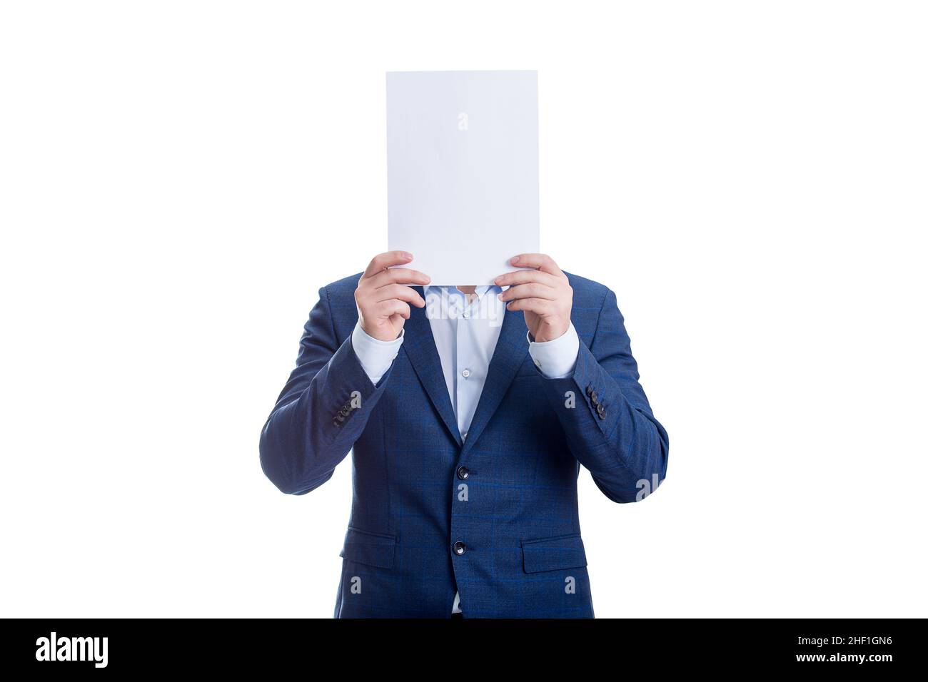 Anonymous businessman covering face with a blank paper sheet, like a mask to hide emotions. Incognito person hidden, isolated on white background. Int Stock Photo