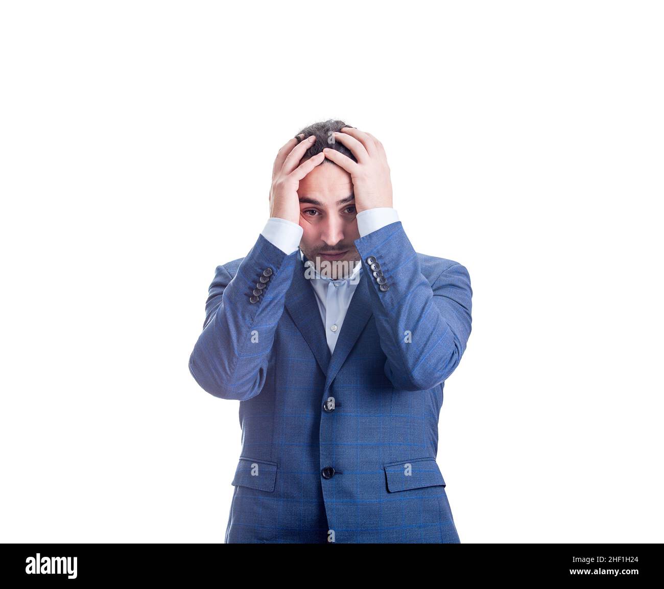 Desperate and depressed businessman looking bewildered, keeps hands to head, messing hair isolated on white background. Irritated and stressed busines Stock Photo