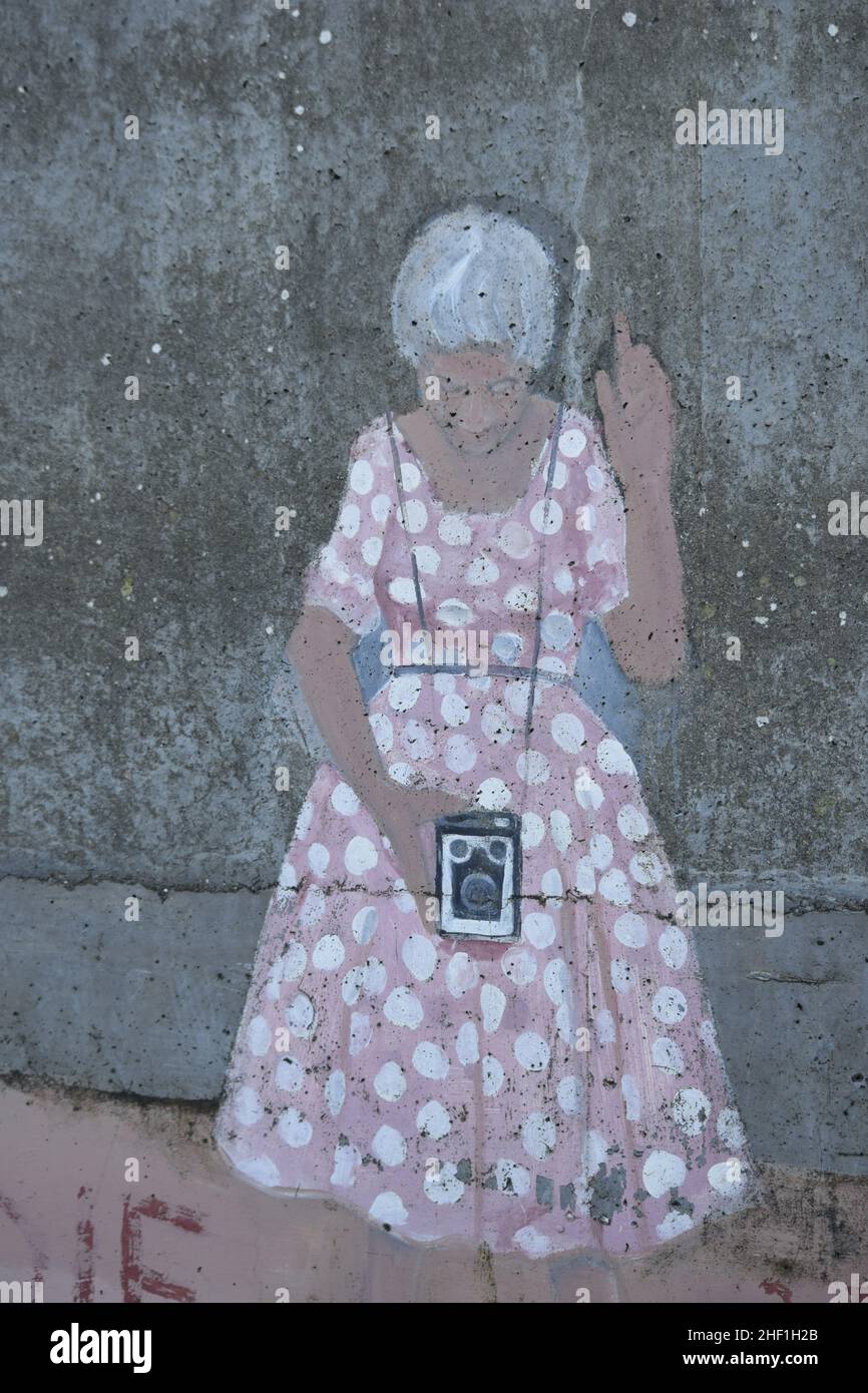 street art of a 1950s woman with a box brownie camera, sheringham, norfolk, england Stock Photo