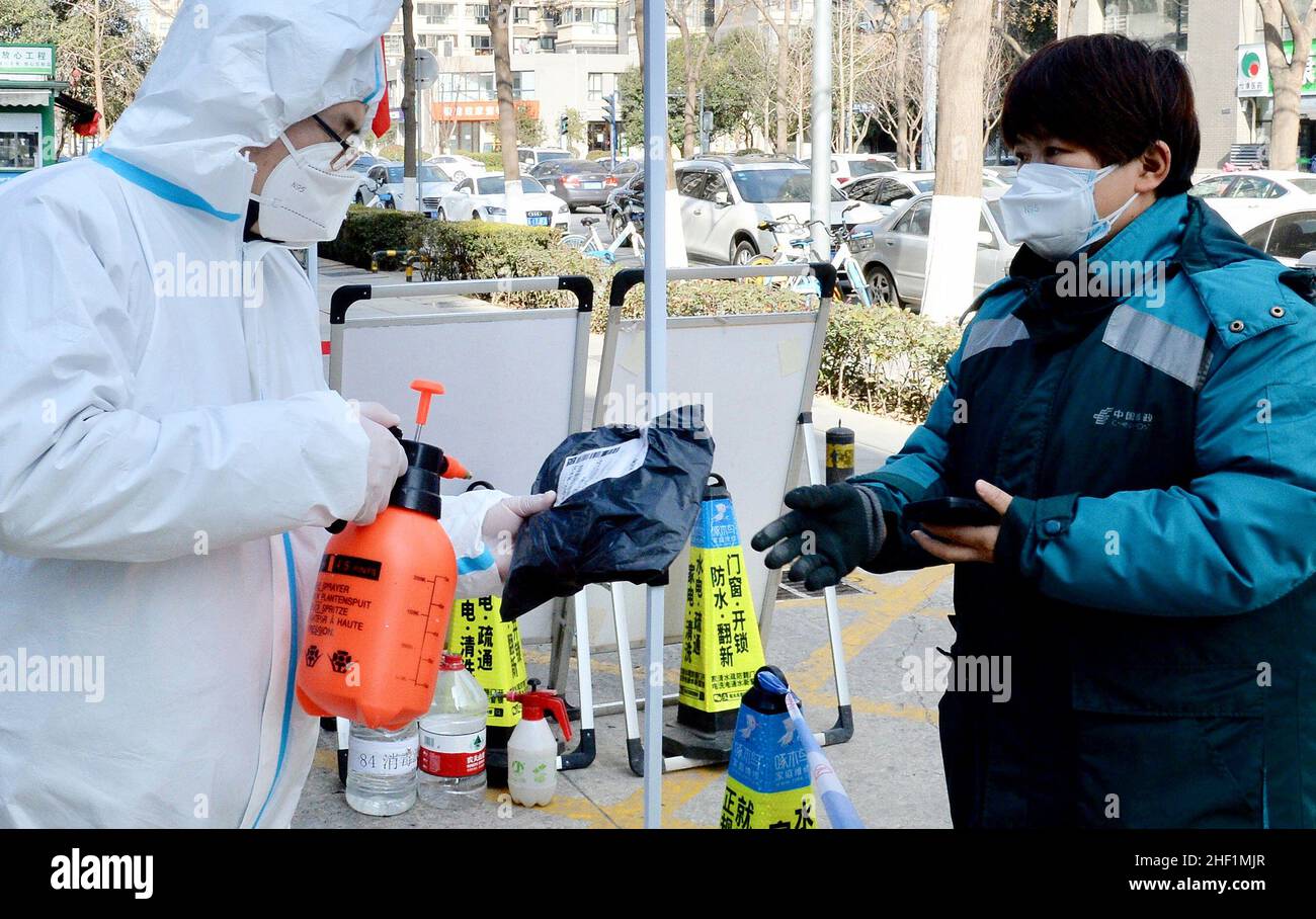 Xi'an, China's Shaanxi Province. 13th Jan, 2022. A volunteer disinfects