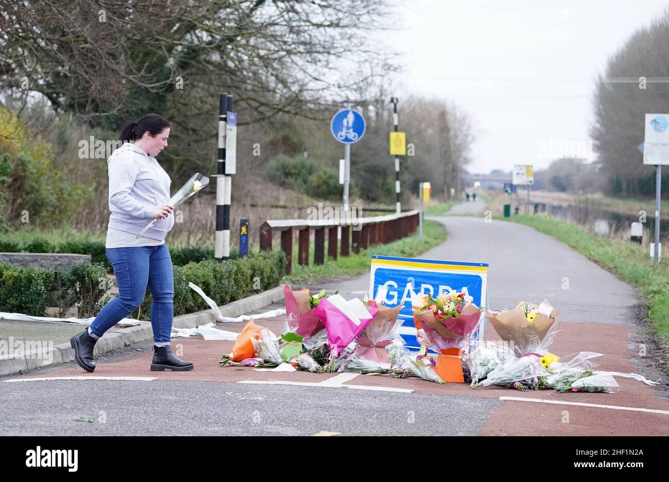 A person lays flowers near to the scene in Tullamore, Co Offaly, after