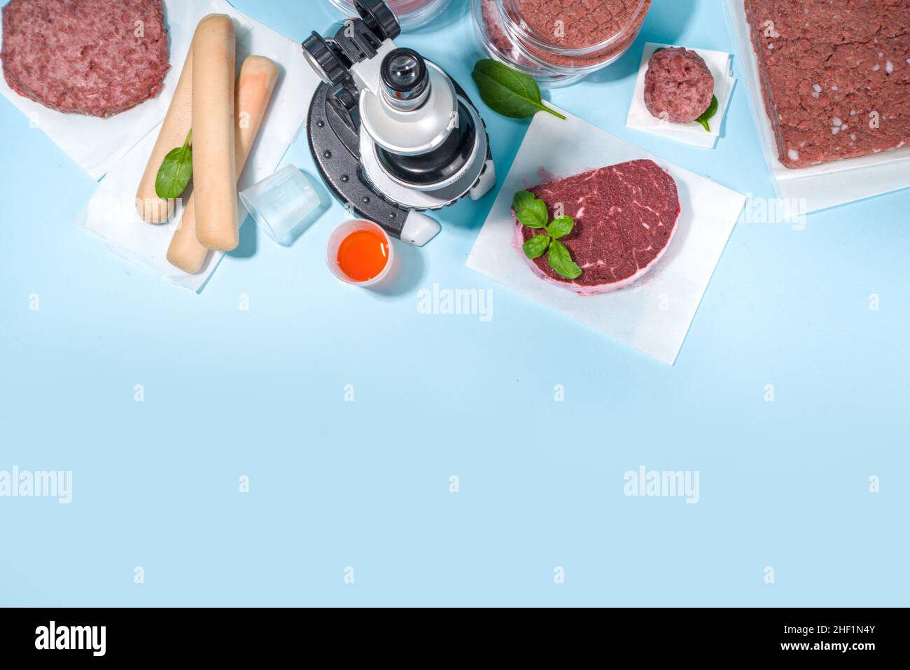 Lab grown meat alternatives concept, Various laboratory grown meat types red and white meat with microscope, laboratory accessories, measuring utensil Stock Photo